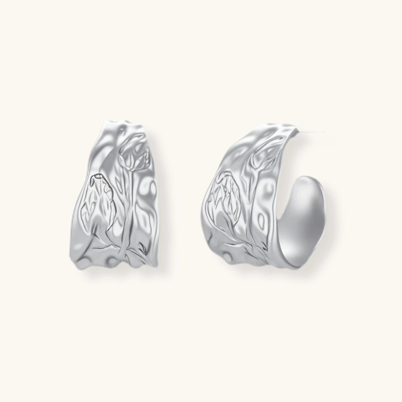 Close-up of textured hoop earrings with liquid metal ripple pattern in eco-zinc alloy with sterling silver posts.